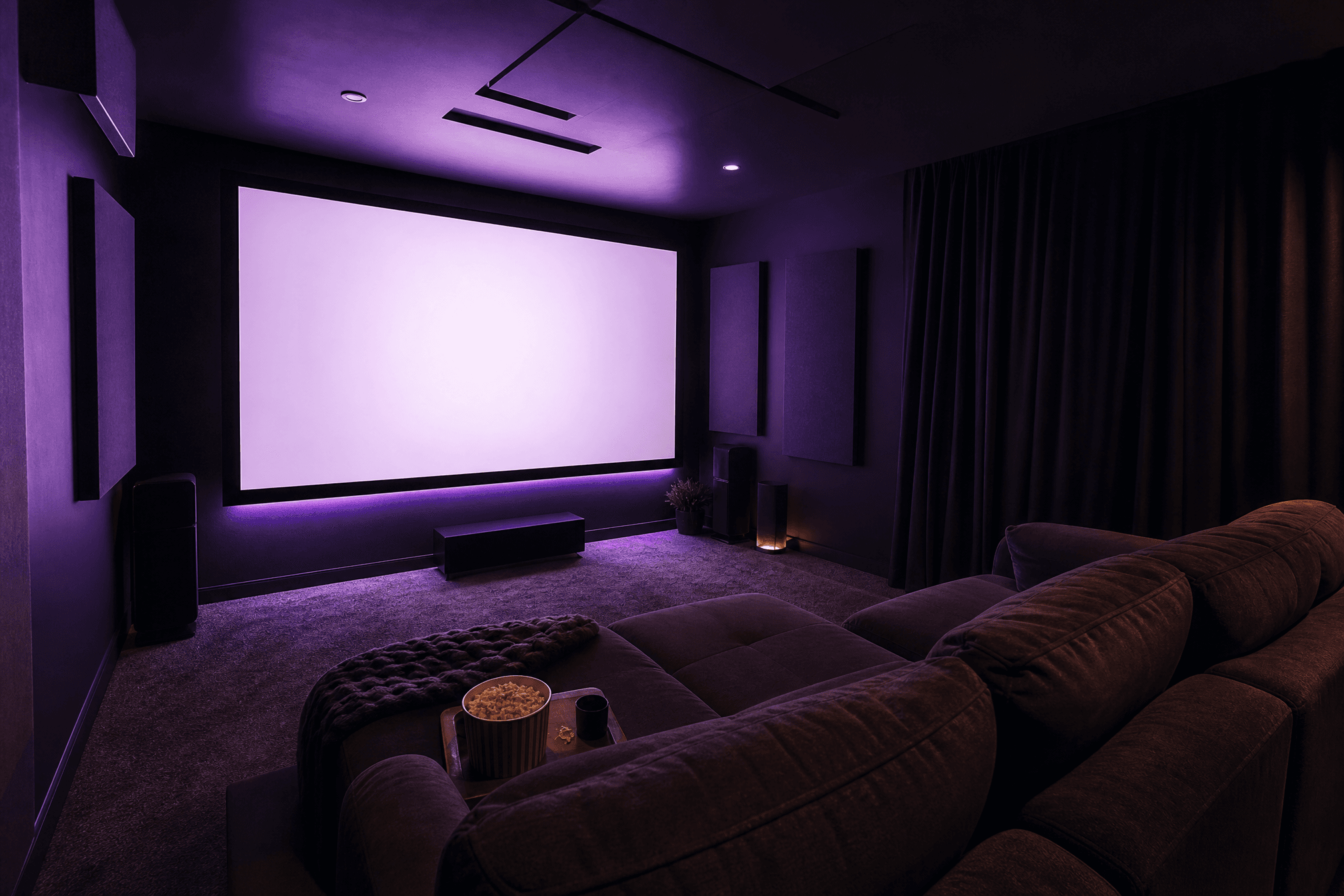 Cosy dark home cinema in use with a glowing screen